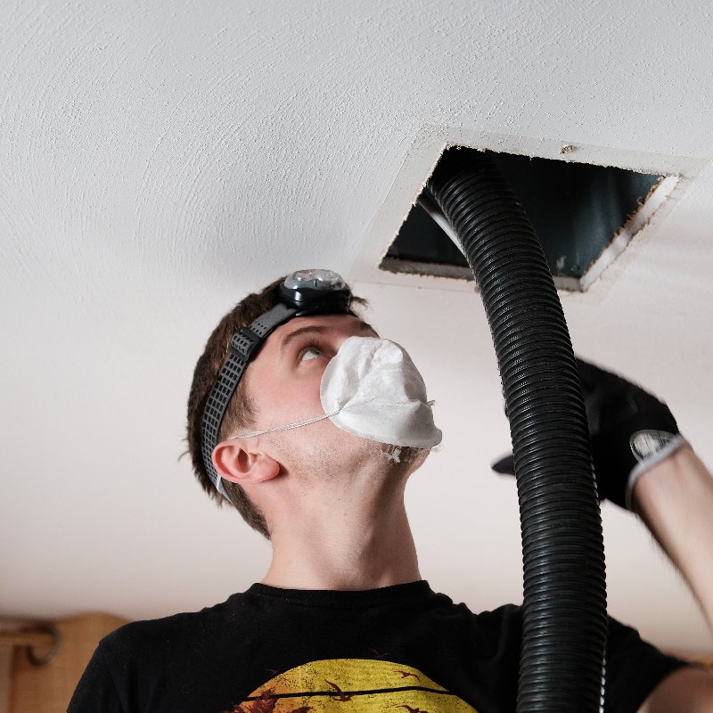 technician providing air duct cleaning services