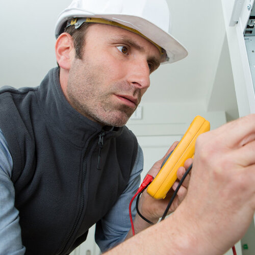 An HVAC technician is fixing a unit