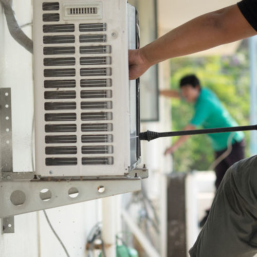 A Technician Cleans Coils,