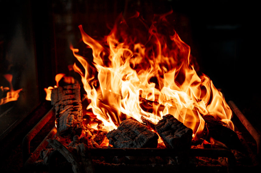 Flame of burning logs in the fireplace