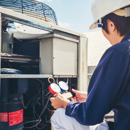 technician checking air conditioner outdoors